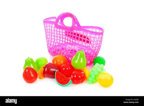 Pink plastic shopping bag with plastic grocery over white background ...