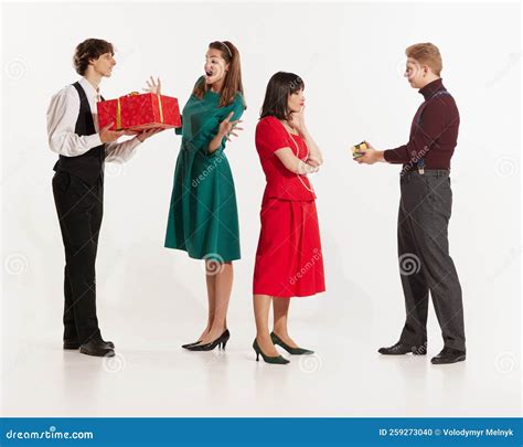 Full Length Portrait Of Young Man Giving His Girlfriend A Present