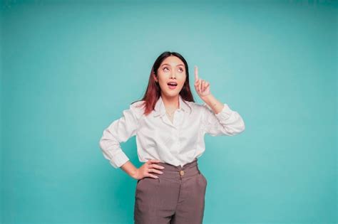 Premium Photo Shocked Asian Woman Wearing White Shirt Pointing At The Copy Space On Top Of Her