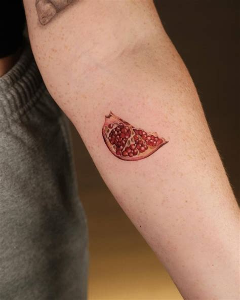 Micro Realistic Pomegranate Tattoo Located On The Inner