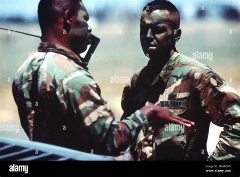 A soldier with a hand radio speaks with another member of the 7th Light ...