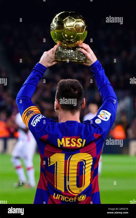 BARCELONA - DEC 7: Messi holds up his sixth Ballon d'Or prior to the ...