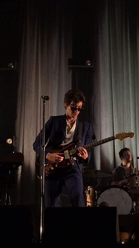 Two Men Are Playing Instruments On Stage