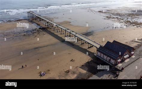 aerial view  saltburn pier extending   sandy beach  calm