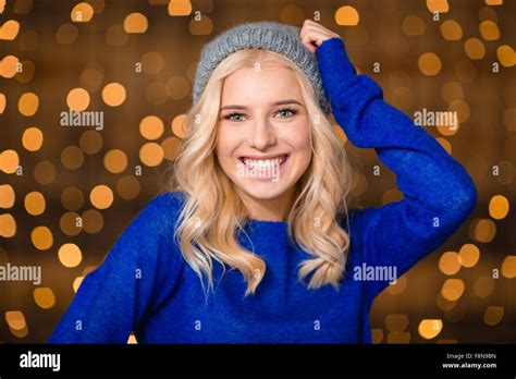 Portrait Of A Smiling Blonde Woman Standing Over Holidays Lights Background Stock Photo Alamy