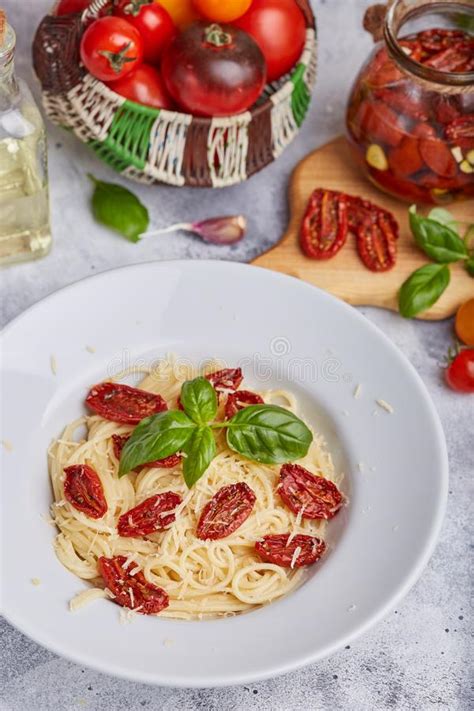 Spaghetti Pasta With Sun Dried Tomatoes Basil Leaf And Parmesan Cheese