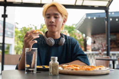 Thai Gay Teen Male Eating Pepperoni Pizza In Outdoor Restaurant Stock Photo Image Of Food