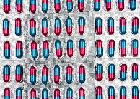 Colorful of blue, pink capsule with granule in side pills. Pills in