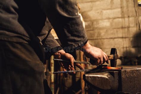 Blacksmith Makes An Artistic Forging Of Hot Metal On The Anvil Stock Photo Image Of Worker