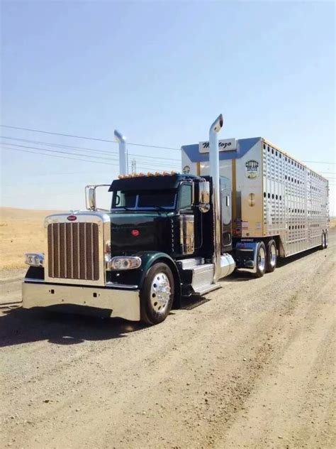 A Semi Truck Hauling A Trailer Down A Dirt Road