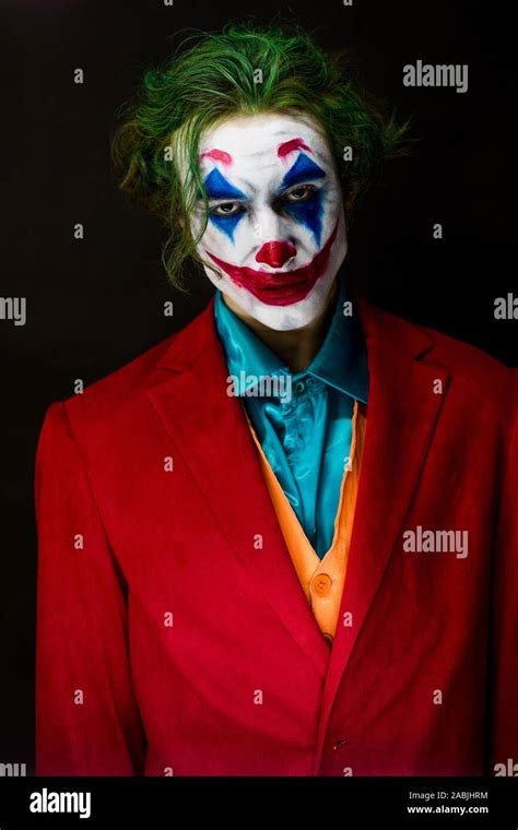 Man Impersonating The Joker Portrait Of A Man In A Suit With Clown