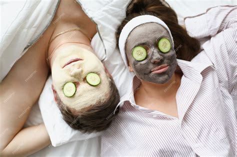 Premium Photo Man And Woman Apply Clay Mask For Rejuvenation On Face