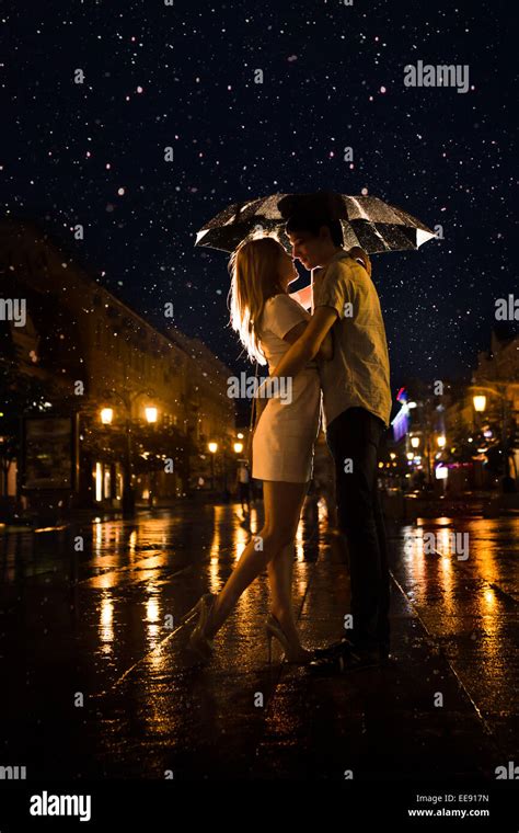 Love In The Rain Silhouette Of Kissing Couple Under Umbrella Stock