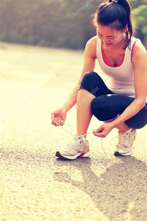 Woman Runner Tying Shoelaces Stock Photo By ©lzf 54664883