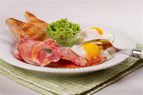 Bacon Poached Eggs Mashed Peas And Toasts On White Plate Grilled