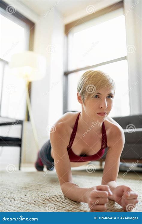 Trendy Woman Doing Plank Exercises As Part Of Her Fitness Morning