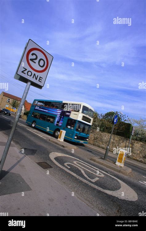 Bus Passing 20 Miles Per Hour Speed Limit Zone Warning Sign On Road