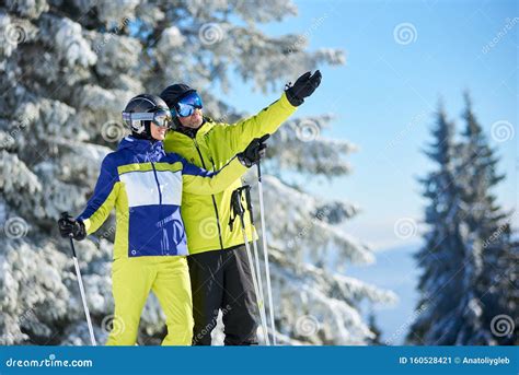 Happy Couple Skiers Posing On Skis Before Skiing At Ski Resort Clear