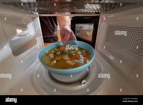 Heating food in a microwave oven Stock Photo - Alamy