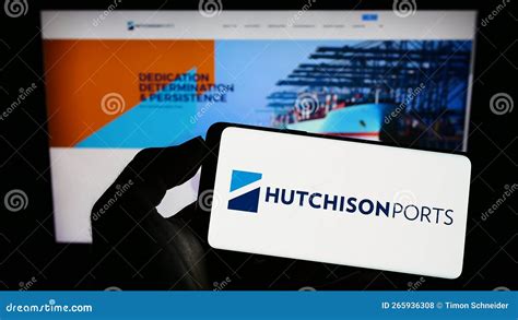 Person Holding Mobile Phone With Logo Of Company Hutchison Port