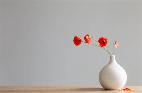 Premium Photo Red Poppies In Vase On Gray Background