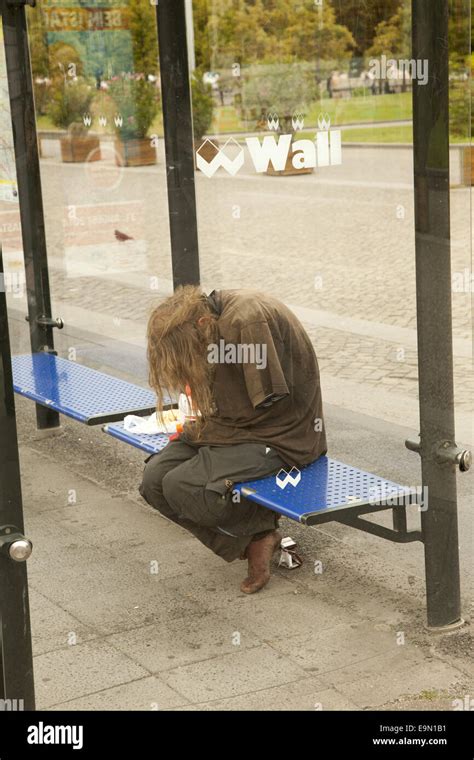 Disheveled Homeless And Mentally Ill Man At A Bus Stop In Berlin