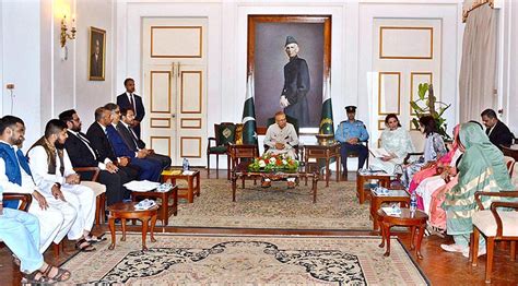 President Dr Arif Alvi Along With Begum Samina Arif Alvi Holding A