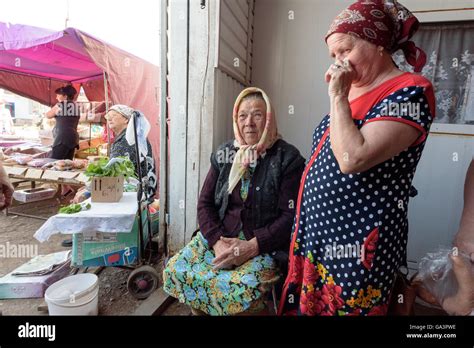 Old Russian Babushka Grandmother Sitting Down And Selling Her Produce