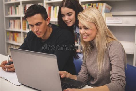 Group Of Friends Enjoying Studying Together At The Library Stock Photo