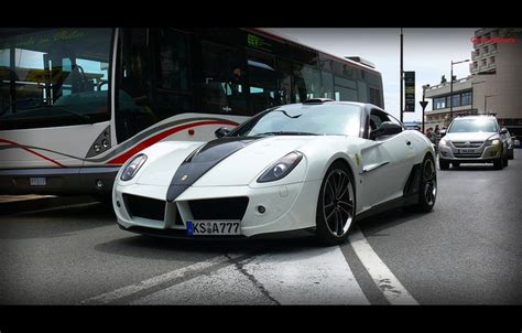 A White Sports Car Parked In Front Of A Bus