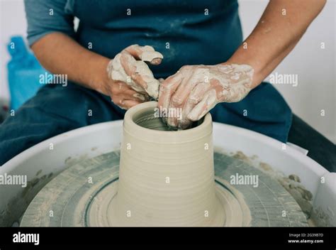 Woman Moulding Clay On A Pottery Wheel Making A Vase Stock Photo Alamy