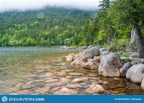 Scenic View Of Jordan Pond In Acadia National Park Surrounded By Green