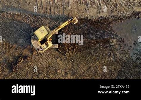 Excavator Dig Ground At Construction Site Aerial View Of A Wheel