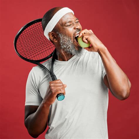 One Happy Mature African American Man Standing Against A Red Background