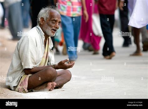 Old blind Indian beggar on the street in front of a crowd. Andhra ...