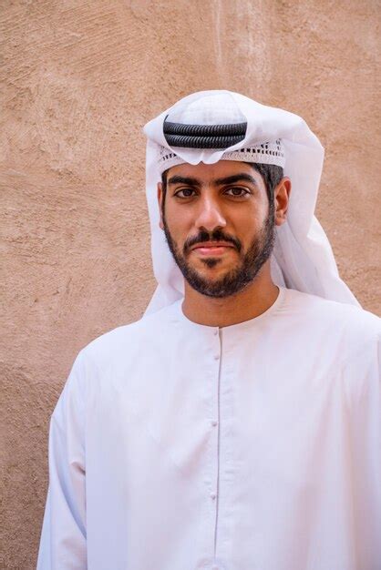 Premium Photo Portrait Of Man Wearing Hat Standing Against White Wall