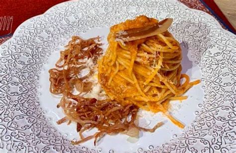 A White Plate Topped With Pasta And Onions