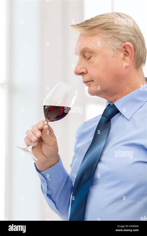 Older Man Smelling Red Wine Stock Photo Alamy