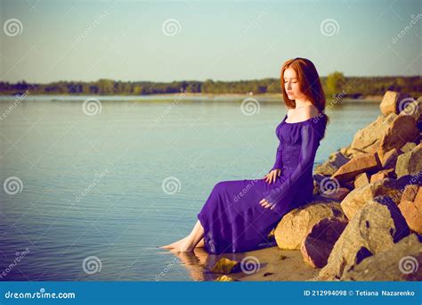 Woman In Purple Long Dress At Nature Fashionable Concept Stock Photo