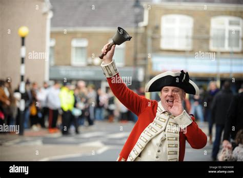 A Traditional Town Crier Rings A Bell And Shouts In A Town Centre