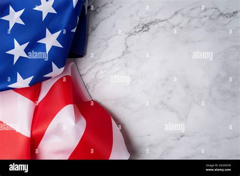 Background With The Flag Of The United States On A White Marble Base