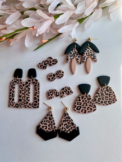 The Leopard Print Earrings And Earring Set Are On Display Next To Some