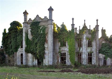 An Old Abandoned Building With Ivy Growing On It S Walls And Windows