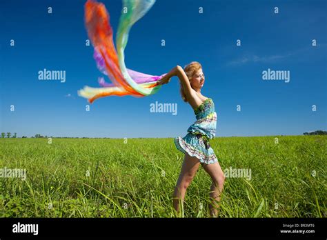 Beautiful Blonde Woman With Colorful Scarf In The Wind Motion Blur Stock Photo Alamy