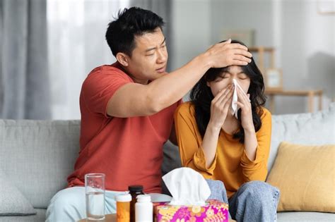 Premium Photo Loving Asian Man Husband Taking Care Of His Sick Wife