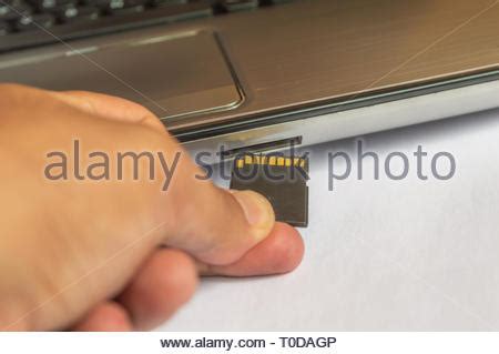 Inserting SD Card into a laptop computer. Closeup Stock Photo: 92130162 ...