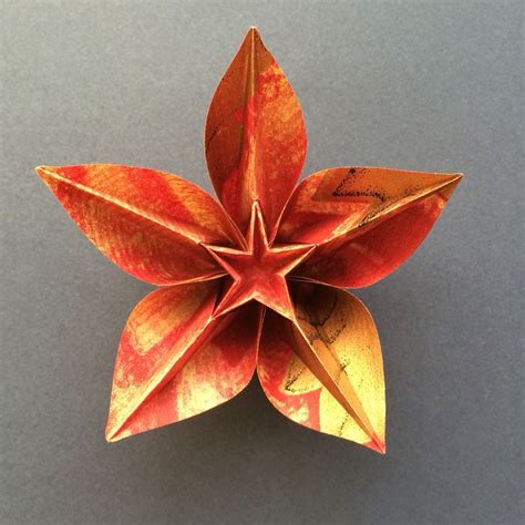 An Origami Flower On A Gray Surface