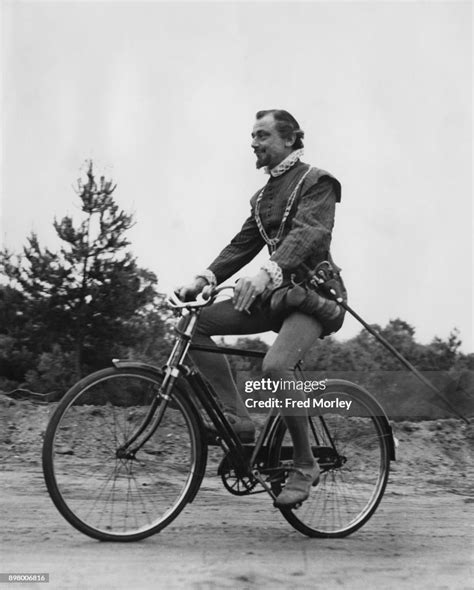 British actor Patrick Cargill uses an anachronistic-looking bicycle ...