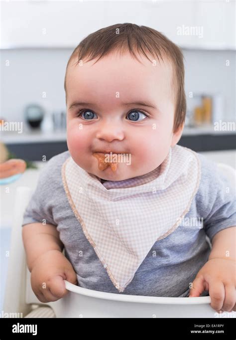 Messy baby eating food Stock Photo - Alamy