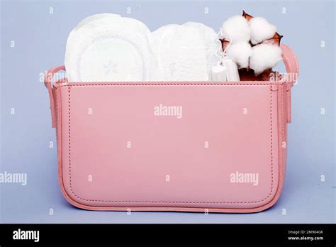 Tampons Hygienic Panty Liners Feminine Sanitary Pads In A Womens Pink Cosmetic Bag On A